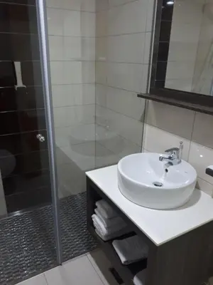 a bathroom with a sink and a shower at Hotel Rekic in Bihać