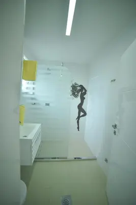 a bathroom with a reflection of a person in a glass wall at Hotel Vrata Bosne in Velika Kladuša