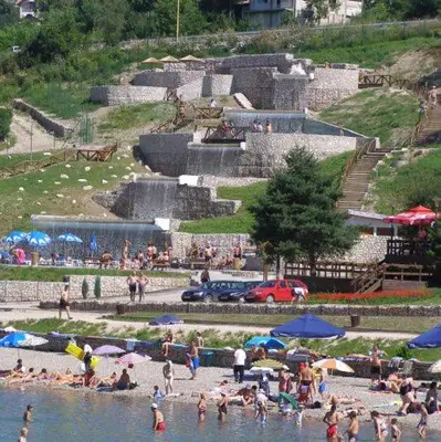 a group of people on a beach near the water at Heartland City B&B in Tuzla