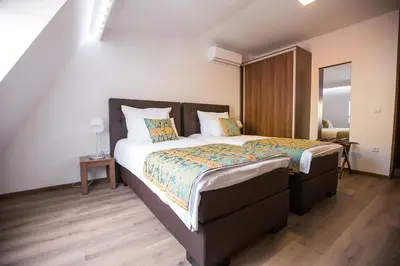 a bedroom with a large bed in a room at Heartland City B&B in Tuzla