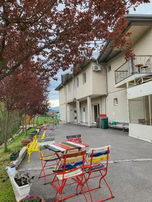 a row of tables and chairs in front of a building at Nihad B&B in Visoko