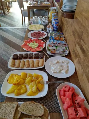 a table with many plates of food on it at Nihad B&B in Visoko