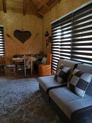 a living room with a couch and a table at Forest Lodge on the Pyramid in Visoko