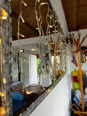a mirror with christmas lights on a wall at Holiday Home Amila in Visoko