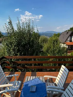 a wooden table with chairs and a remote control on it at Holiday Home Amila in Visoko