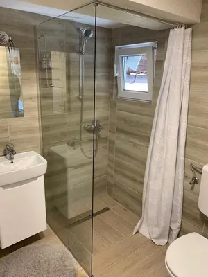 a bathroom with a shower and a toilet and a sink at Holiday Home Amila in Visoko