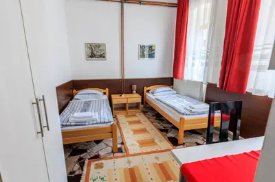 a small room with two beds and a window at Apartments Villa Kobilj in Banja Luka