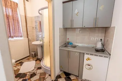 a small bathroom with a sink and a toilet at Apartments Villa Kobilj in Banja Luka