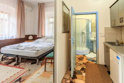 a bedroom with a bed and a bathroom at Apartments Villa Kobilj in Banja Luka