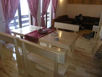 a living room with a table and a couch at Planinska kuća Kupres in Kupres
