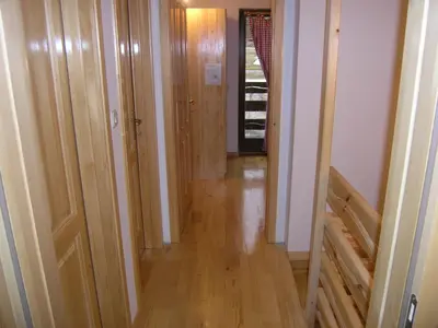 a hallway with wood floors and a hallway with wooden doors at Planinska kuća Kupres in Kupres