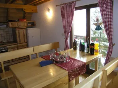 a wooden table in a kitchen with a table and a table at Planinska kuća Kupres in Kupres
