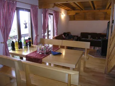 a living room with a table and a couch at Planinska kuća Kupres in Kupres