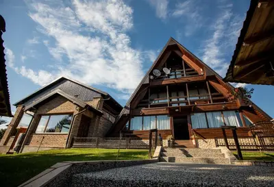 a large house with a gambrel roof with stairs at Hotel Babino Brdo in Derventa