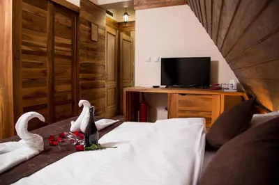 a hotel room with a bed with swans on it at Hotel Babino Brdo in Derventa