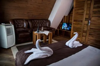 two swans towels on a bed in a room at Hotel Babino Brdo in Derventa