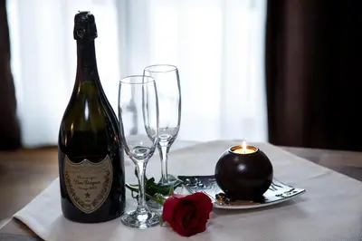 a bottle of wine and two glasses on a table at Hotel Babino Brdo in Derventa