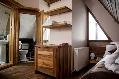 a bathroom with a sink and a toilet in a room at Hotel Babino Brdo in Derventa