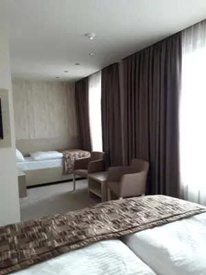 a hotel room with a bed and a bedroom at Hotel Palazzo in Gornji Vakuf