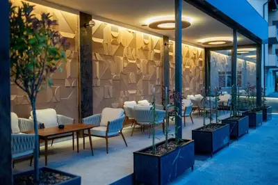 a restaurant with chairs and tables in a building at Hotel Palazzo in Gornji Vakuf