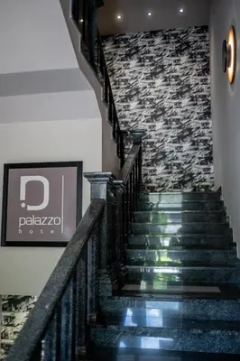 a staircase in a building with a stone wall at Hotel Palazzo in Gornji Vakuf