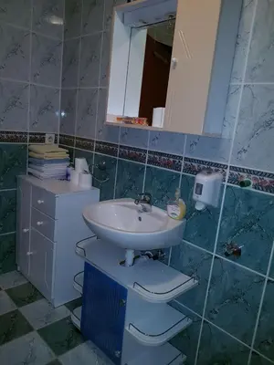 a bathroom with a sink and a toilet and a mirror at Apartments Kenedy in Kiseljak