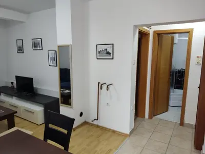 a living room with a table and a bathroom at Apartmani Čolić Vlašić in Vlasic