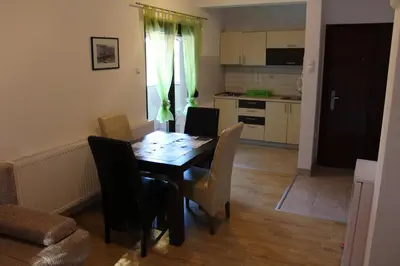 a kitchen and dining room with a table and chairs at Apartmani Čolić Vlašić in Vlasic