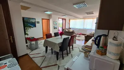 a kitchen and living room with a table and chairs at Hana Superior Apartments in Bihać