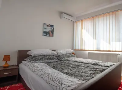 a large bed in a bedroom with a window at Hana Superior Apartments in Bihać