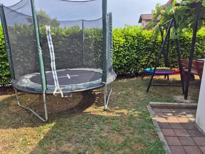 an empty trampoline in a yard with a trampoline at Hana Superior Apartments in Bihać