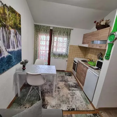 a small kitchen with a white table and a table at Hana Superior Apartments in Bihać