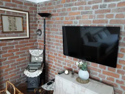 a brick wall with a flat screen tv on a wall at Apartment Sun in Visoko