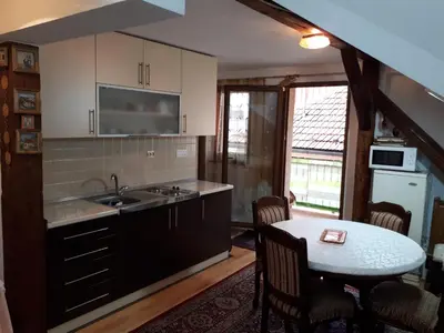 a kitchen with a sink and a table at Apartment Sun in Visoko