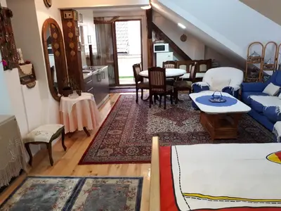 a living room with a blue couch and a table at Apartment Sun in Visoko