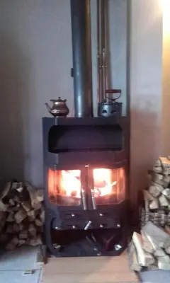 a stove in a room with a fire in it at Chalet The Best View in Vlasic