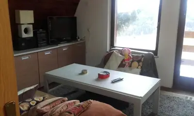 a living room with a coffee table and a tv at Chalet The Best View in Vlasic