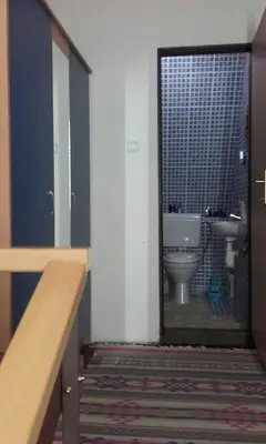 a bathroom with a toilet and a door with a window at Chalet The Best View in Vlasic