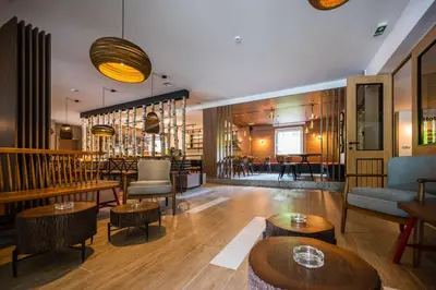a restaurant with tables and chairs and a bar at Hotel Plivsko jezero in Jajce