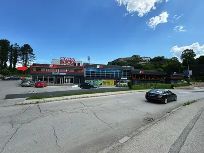 a car driving down a street in front of a building at Hotel Turist 98 in Jajce
