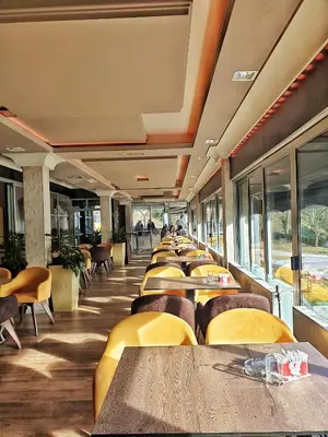 a row of tables and chairs in a restaurant at Hotel Turist 98 in Jajce