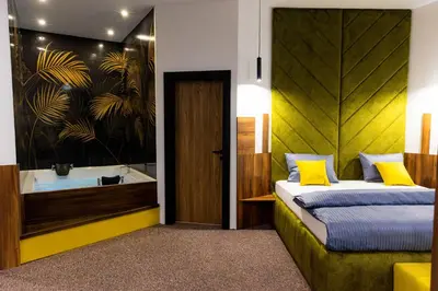 a bedroom with a bed and a bath tub at Hostel Tron in Travnik