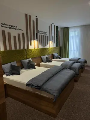 a row of beds in a room at Hostel Tron in Travnik