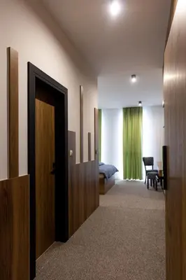 a hotel room with a door and a bedroom at Hostel Tron in Travnik