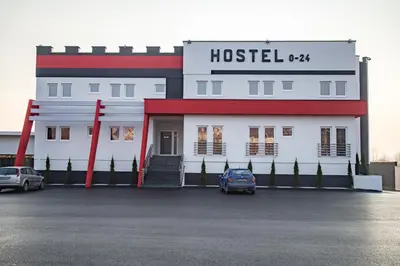 a hotel with a car parked in a parking lot at Hostel Tron in Travnik