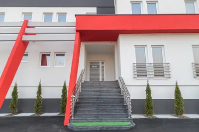 a stairway leading up to a white building at Hostel Tron in Travnik