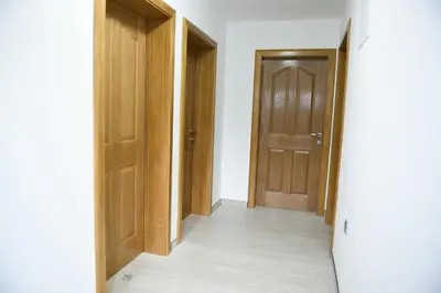 an empty hallway with wooden doors and a floor at Motel Alibi in Banja Luka