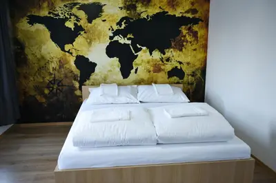 a bedroom with a map of the world on the wall at Motel Alibi in Banja Luka