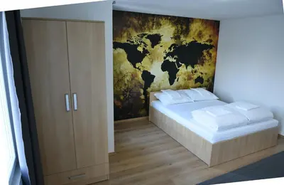 a bedroom with a map of the world on the wall at Motel Alibi in Banja Luka