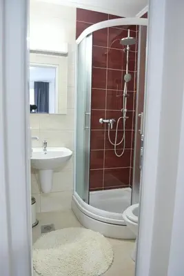 a bathroom with a shower and a toilet and a sink at Motel Alibi in Banja Luka